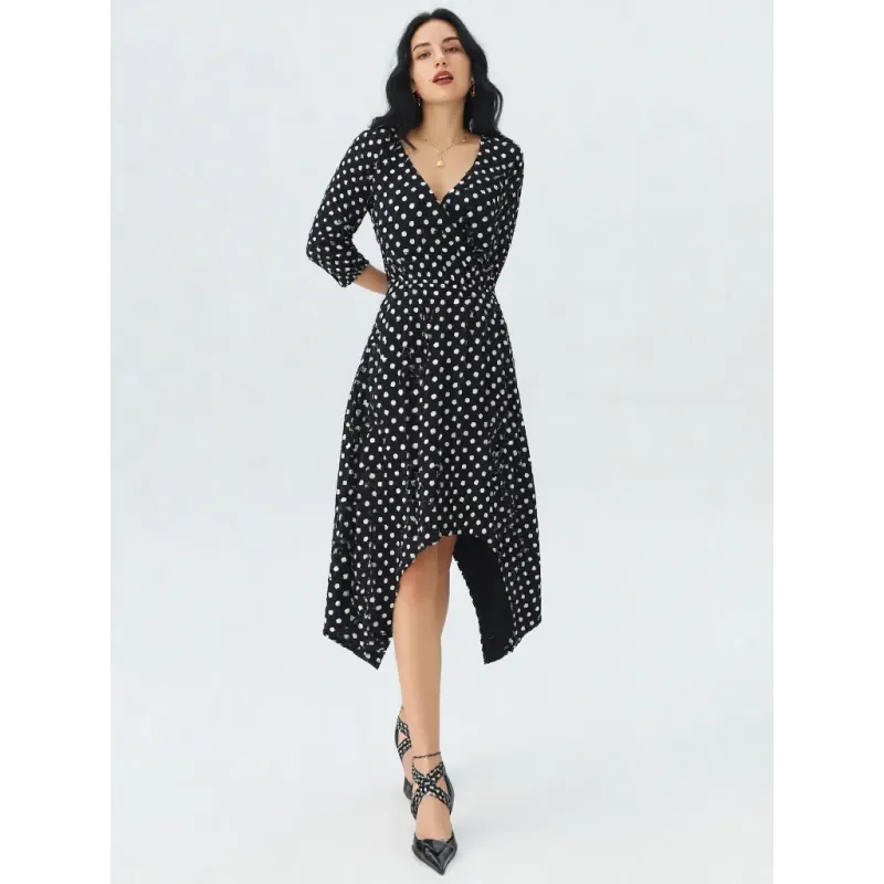Black polka dot midi dress with wrap neckline, long adjustable sleeves and asymmetrical pointed hem